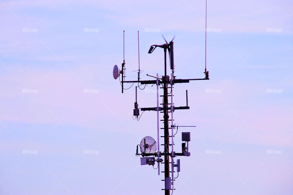 Close-up of an outdoor weather station against a purple evening sky