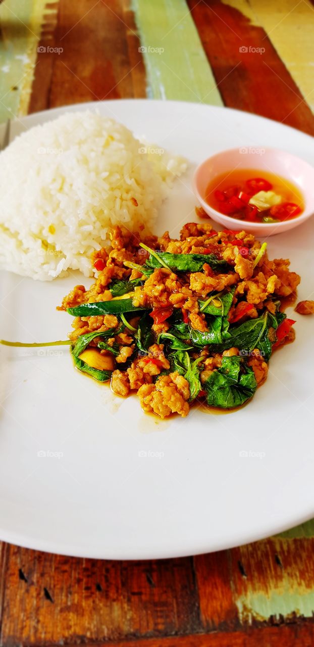 Rice topped with stir fried pork and basil
