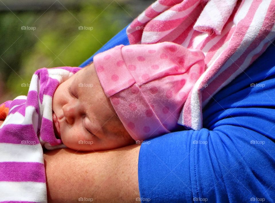 Infant Sleeping In Mother's Arms
