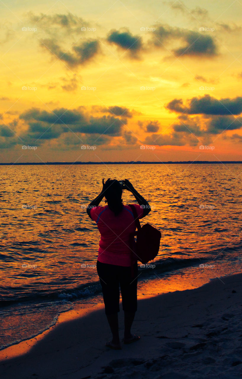 The sky was filled with the most brilliant orange complimented perfectly with hues of gold, yellow, red and crimson. An orange haze had casted over the water, reflecting off every wave. Finally,the sun disappears along with the shine. I can only wait to see another magical moment of beauty and warmth! I can only wait for another sunset! Enjoy!