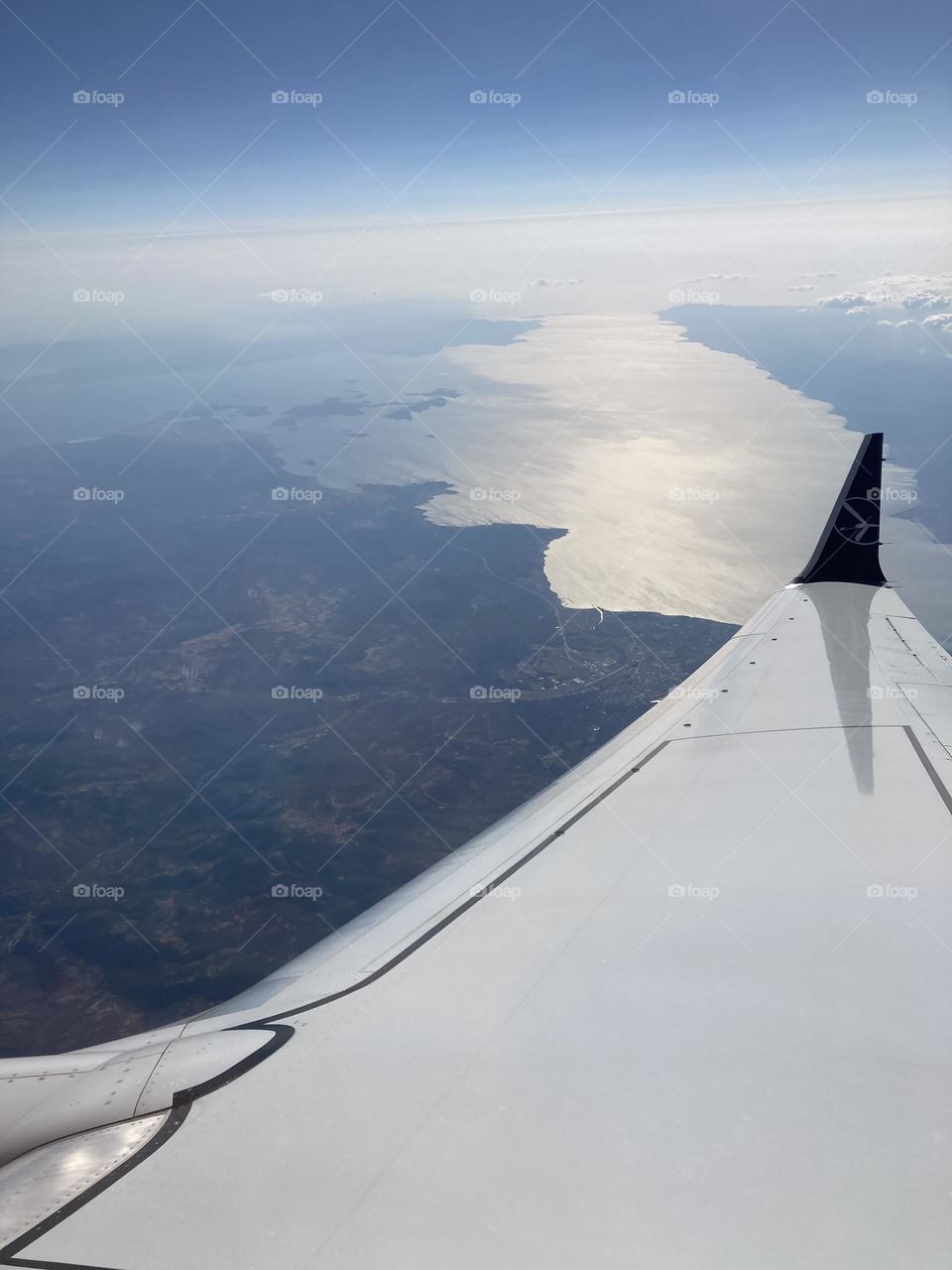 Airplane window seat view. Landscape from the top. With my head in the clouds. Beautiful view from the sky. 