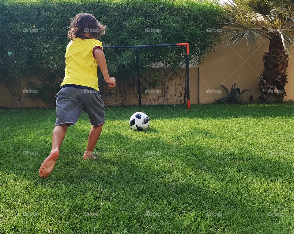 Kid playing soccer 