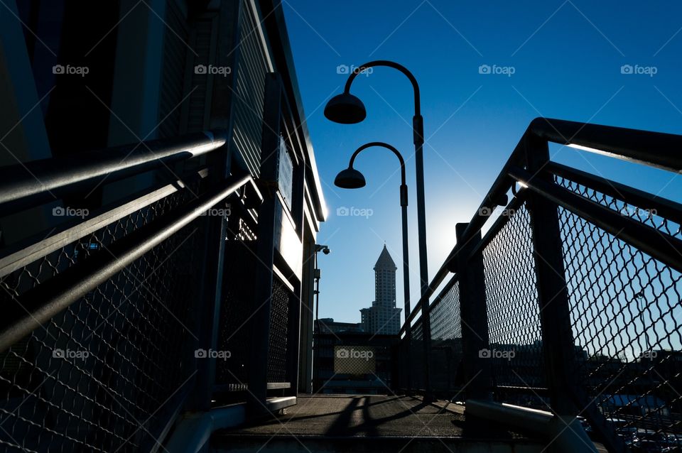 Seattle in the morning. Smith tower in Seattle in the background of stair railing and streetlights