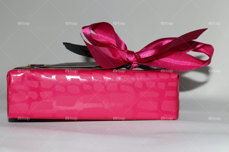 A pink gift box with ribbon 