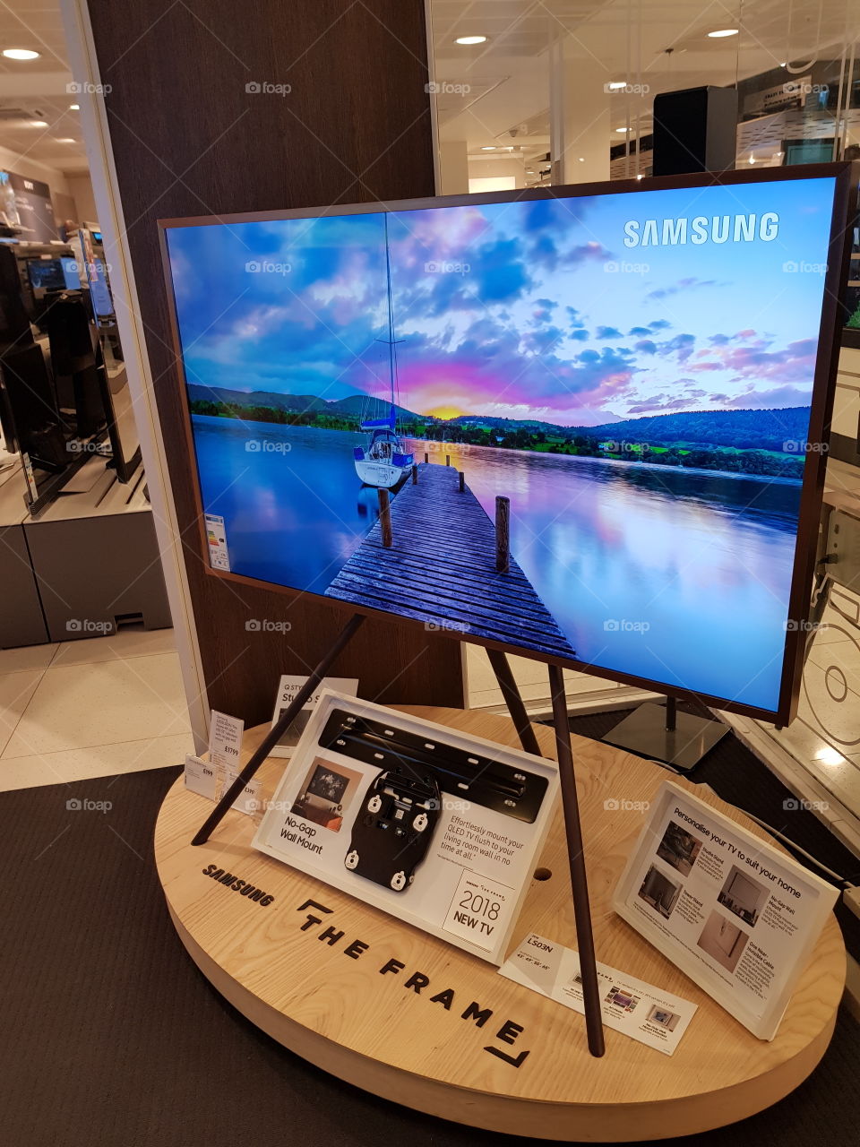 Samsung The Frame TV on studio stand with no gap wall mount and one near invisible cable dynamic crystal colour slideshow