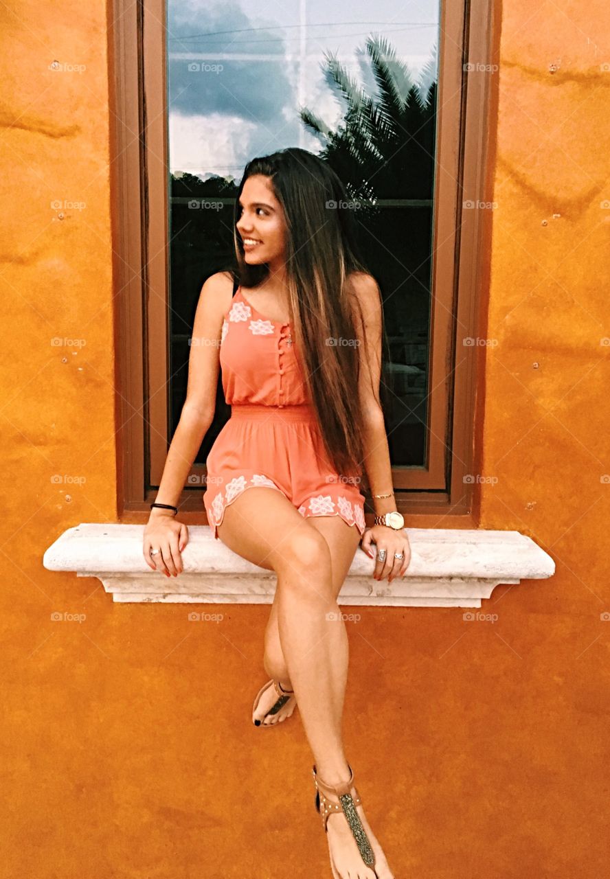 Gorgeous girl sitting on the window sill
