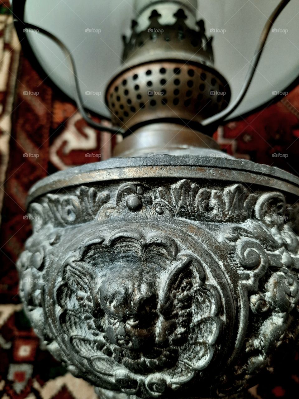 circular ornament on an old metal lamp