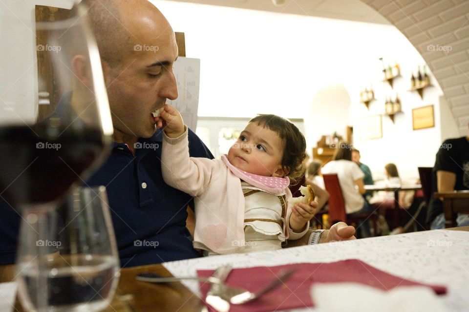 little girl feeding her dad