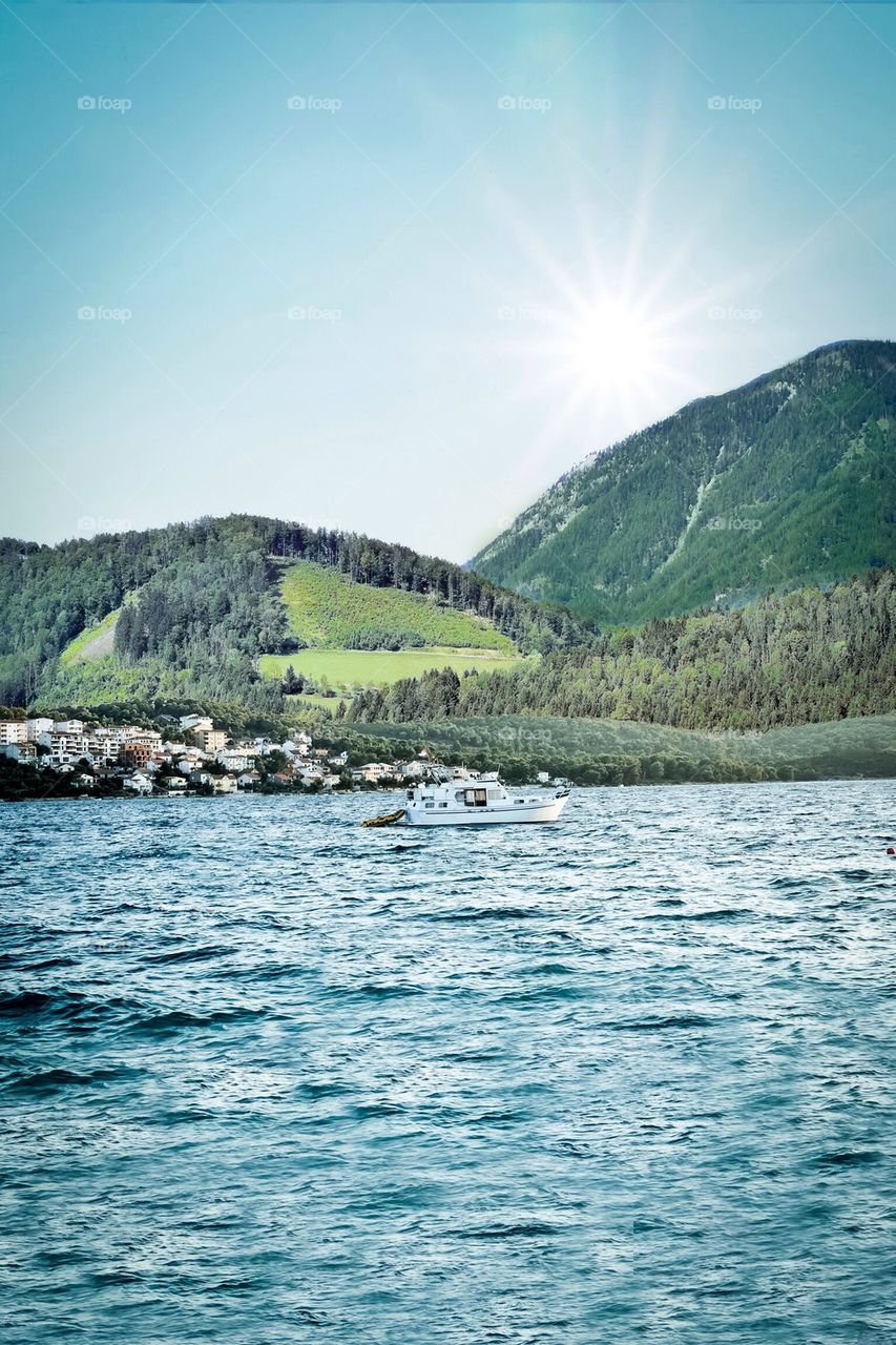 Lake with boat and mountains 