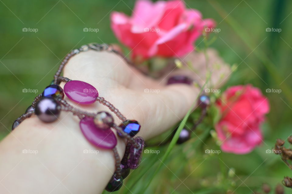 Purple handmade bracelet roses flowers background 