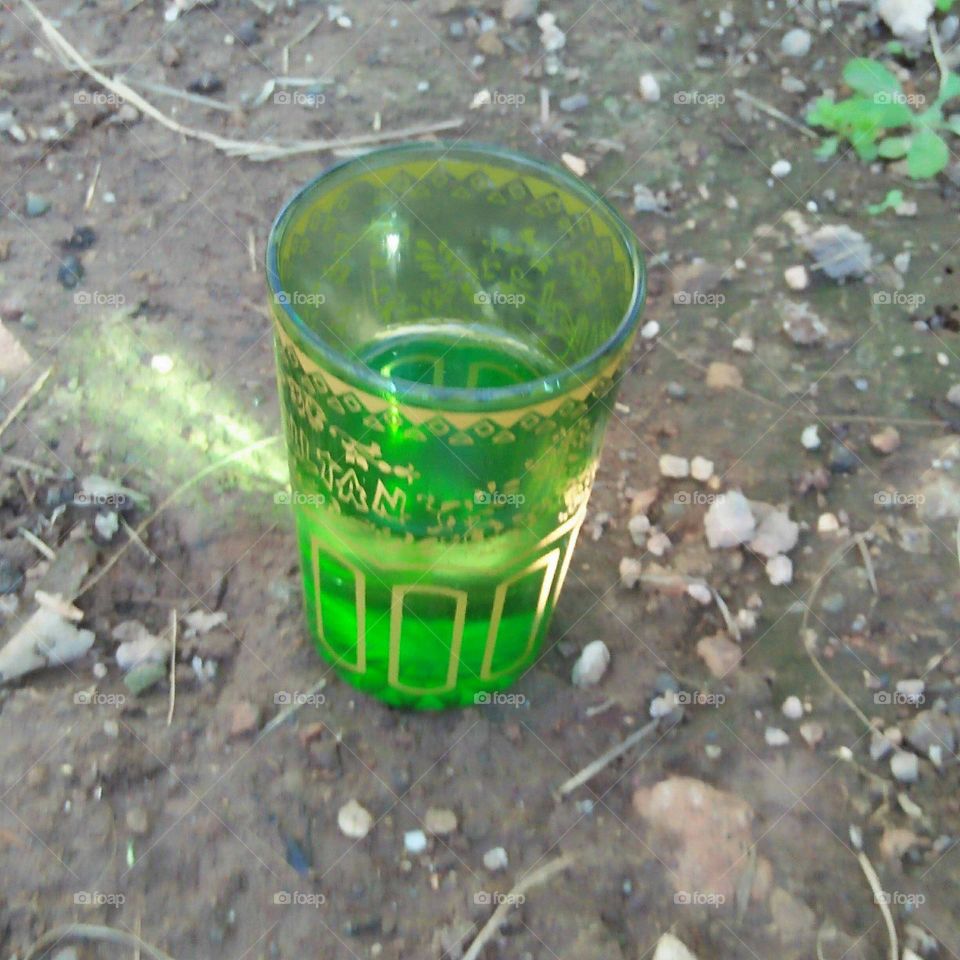 Beautiful green cup on the ground.