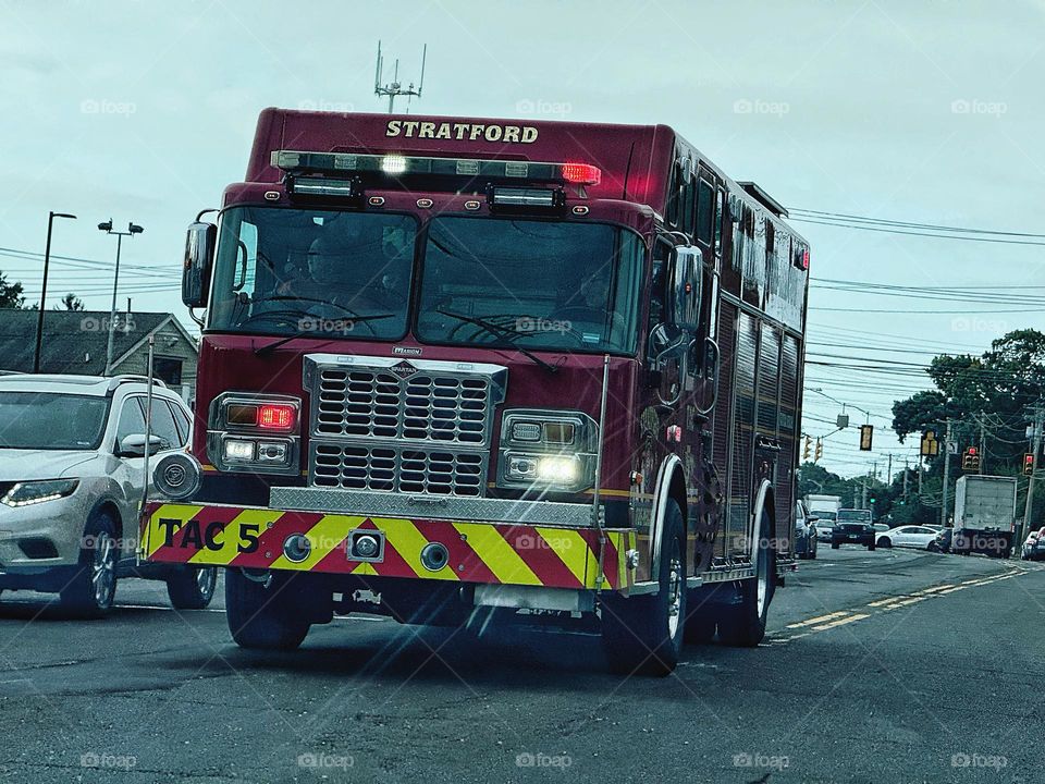 Fire engine moving through traffic on a busy road 