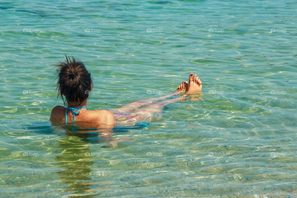 Back side view of girl enjoying the summer and sea