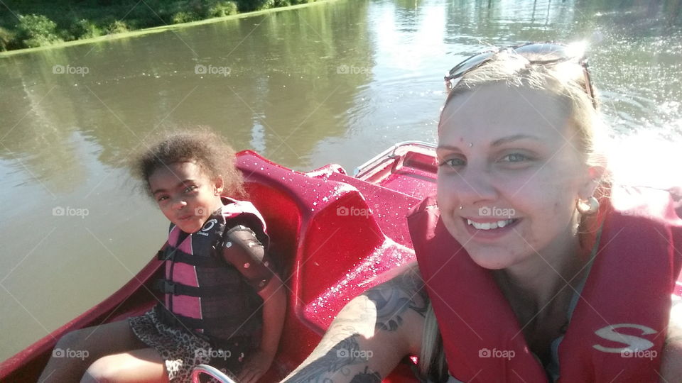mother and daughter on a paddle boat lake