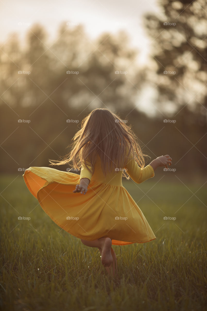 Little girl in yellow dress outdoor portrait 