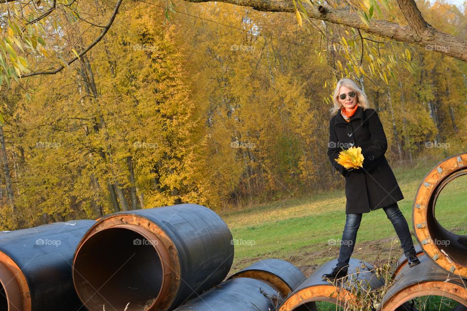 woman with yellow leaves autumn time