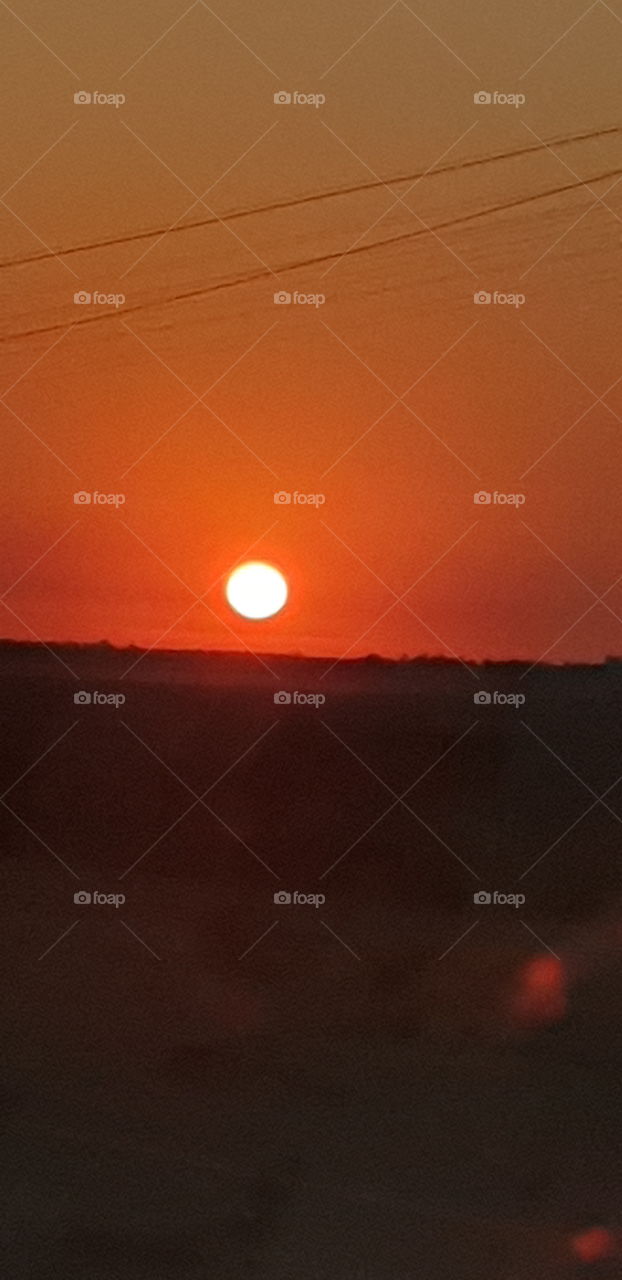 a picture taken of the sun rising while driving to potchefstroom in the north-west province in south africa