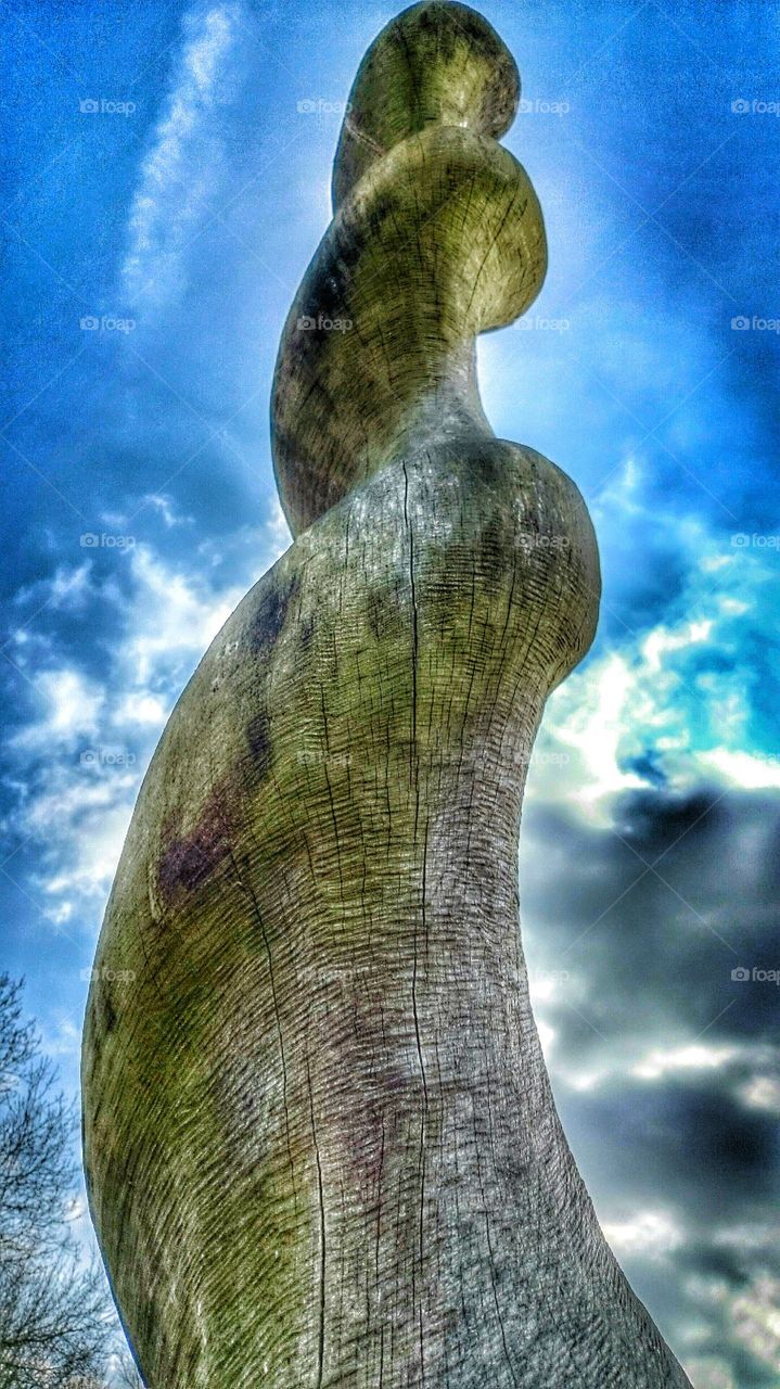 up to the cloud . big wooden statue rising up