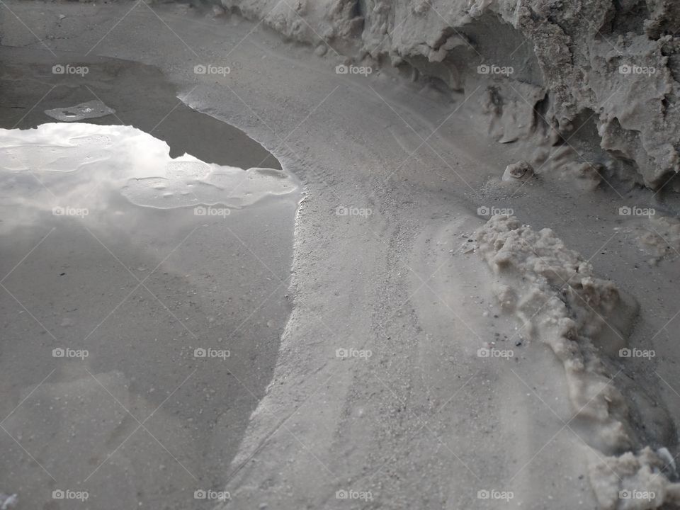 Sand hole with a puddle.