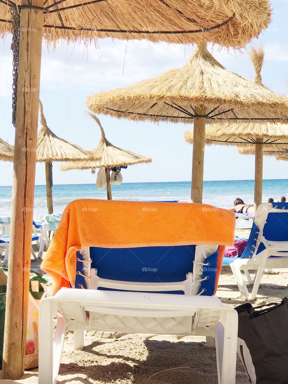 Orange towel on the sunchair