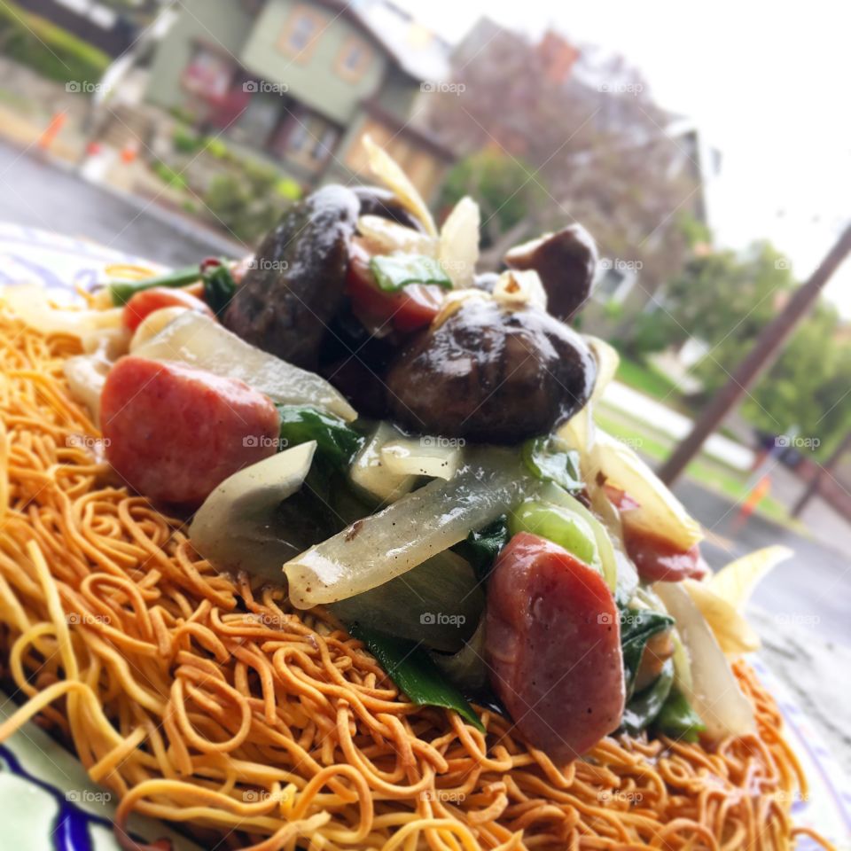 A medley of Chinese sausage and vegetables served with a ginger beef gravy on top of pan fried noodles.

