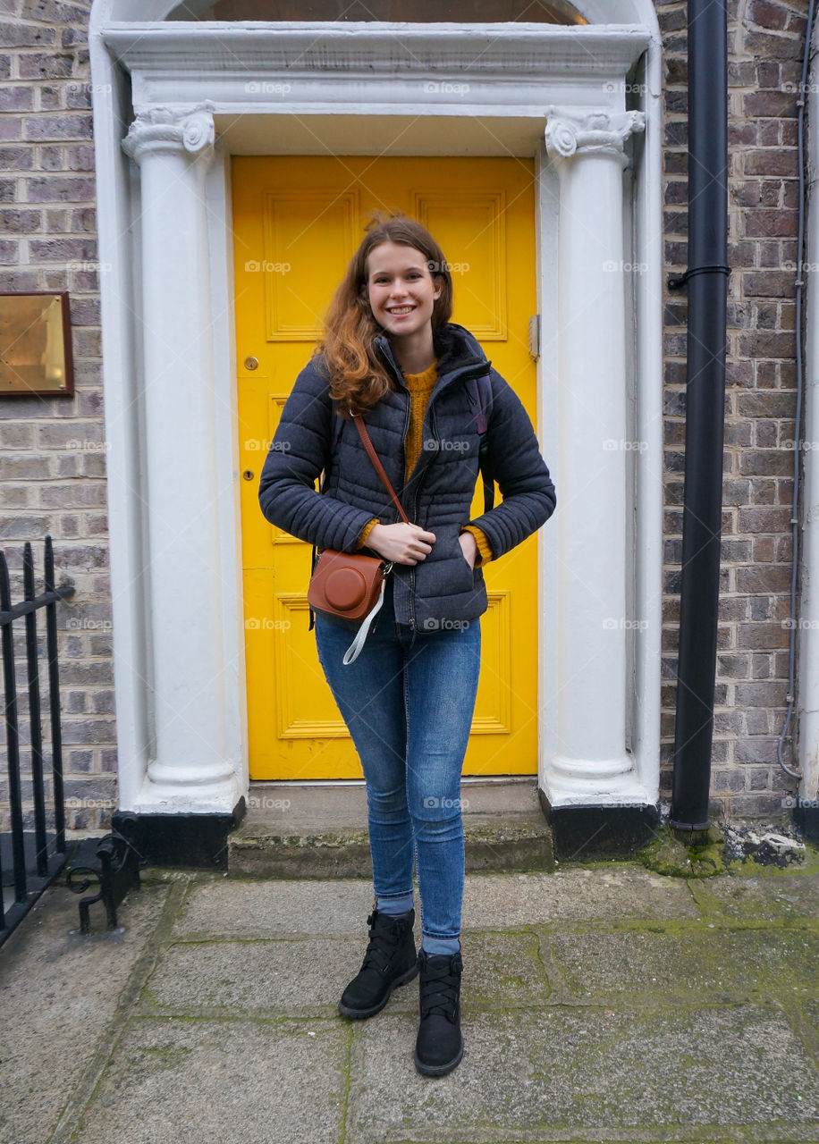 Girl in front of a yellow door in Dublin