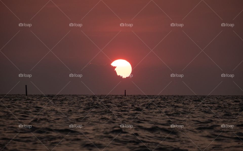 Big sunset into the sea at Thailand famous Bang Saen beach 