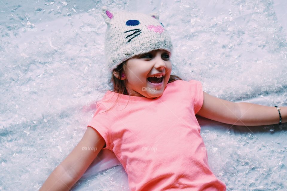 Smiling girl lying on fur