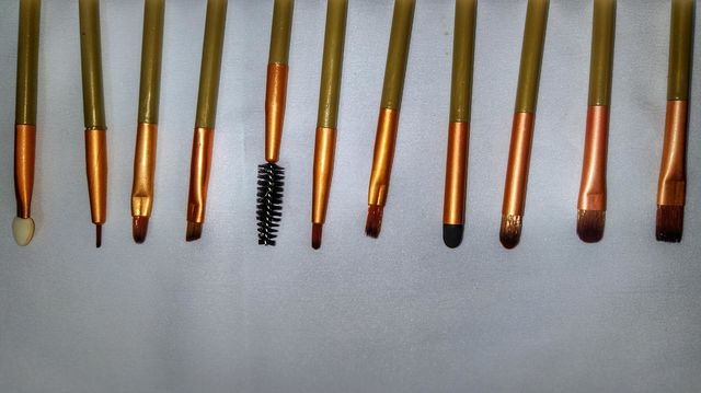 colourful makeup brushes against white background