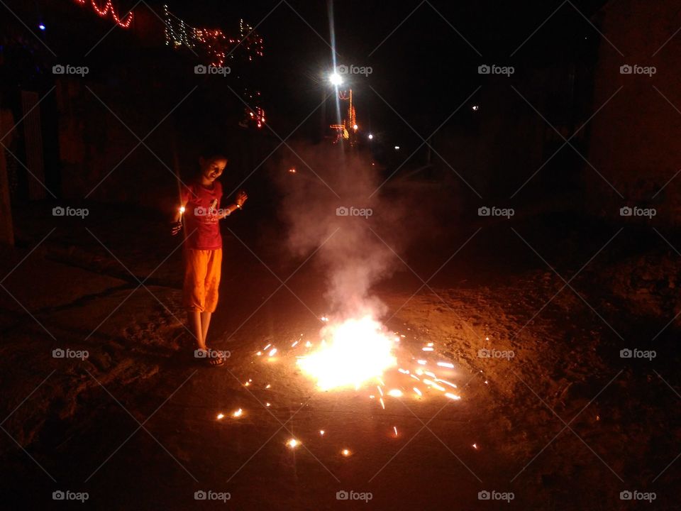 Girl enjoying fireworks at night