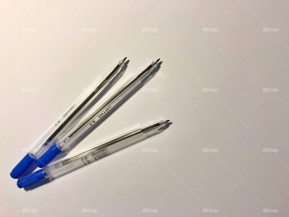 blue pens on white background