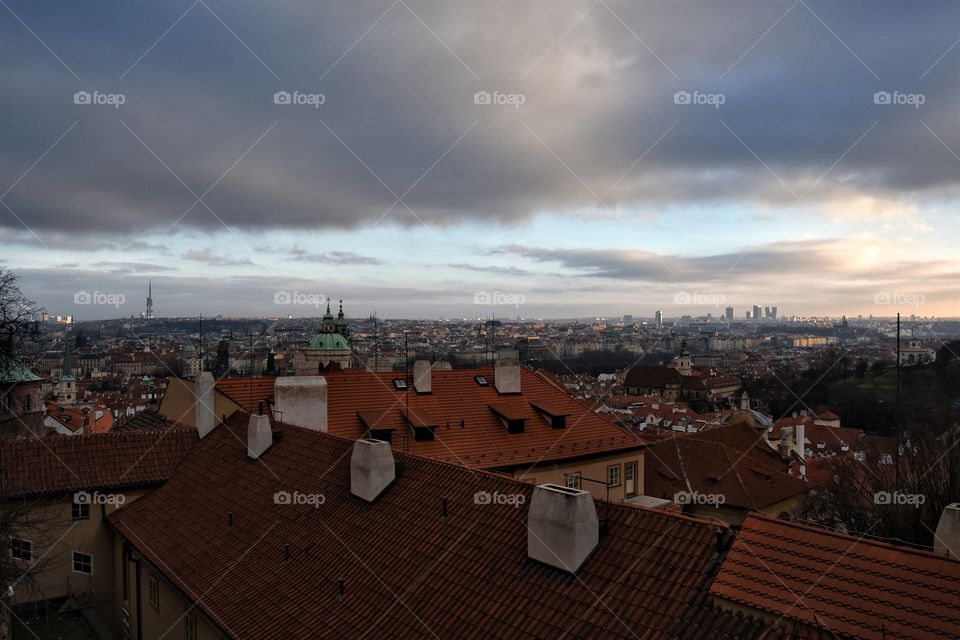 Roof top view of prague city during winter sunset