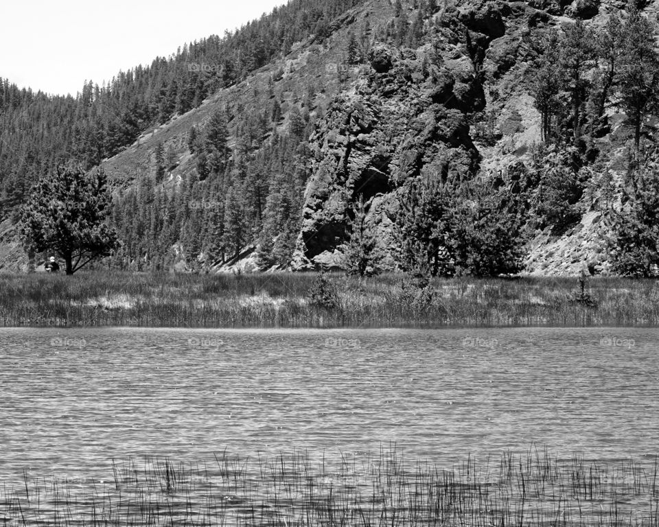 The rocky and rugged side of a hill at East Lake in Central Oregon on a sunny summer day. 