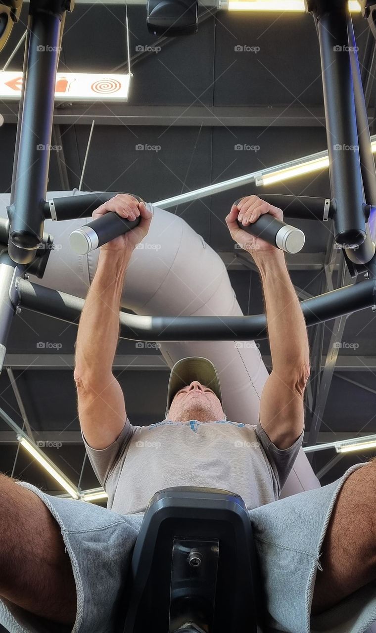 doing some seated hammer strength chest press . targeting the pectoral muscle.