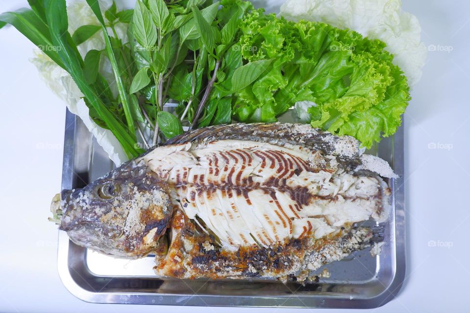 Grilled big tilapia with white meat and vegetables to eat with fish. white background