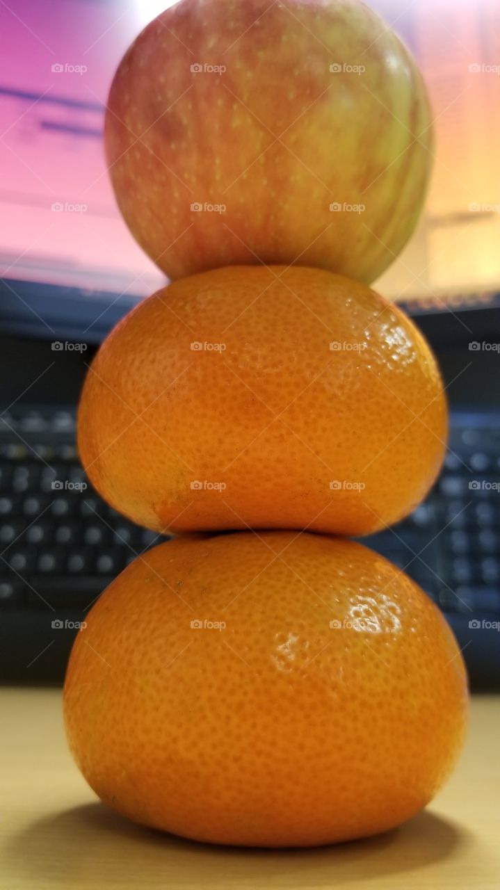 Apple on top of oranges