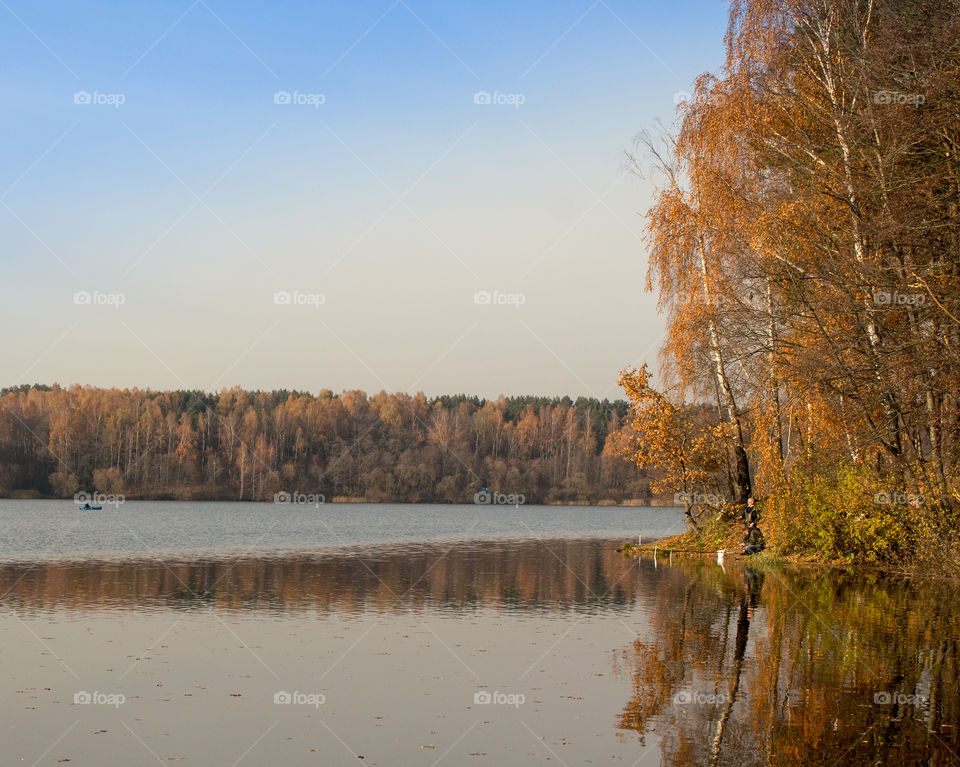 gold autumn. lake. fishermen