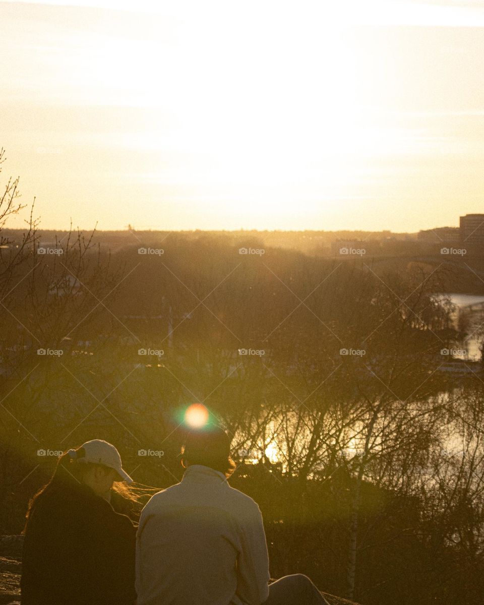 Couple enjoying a sunset in a swedish spring