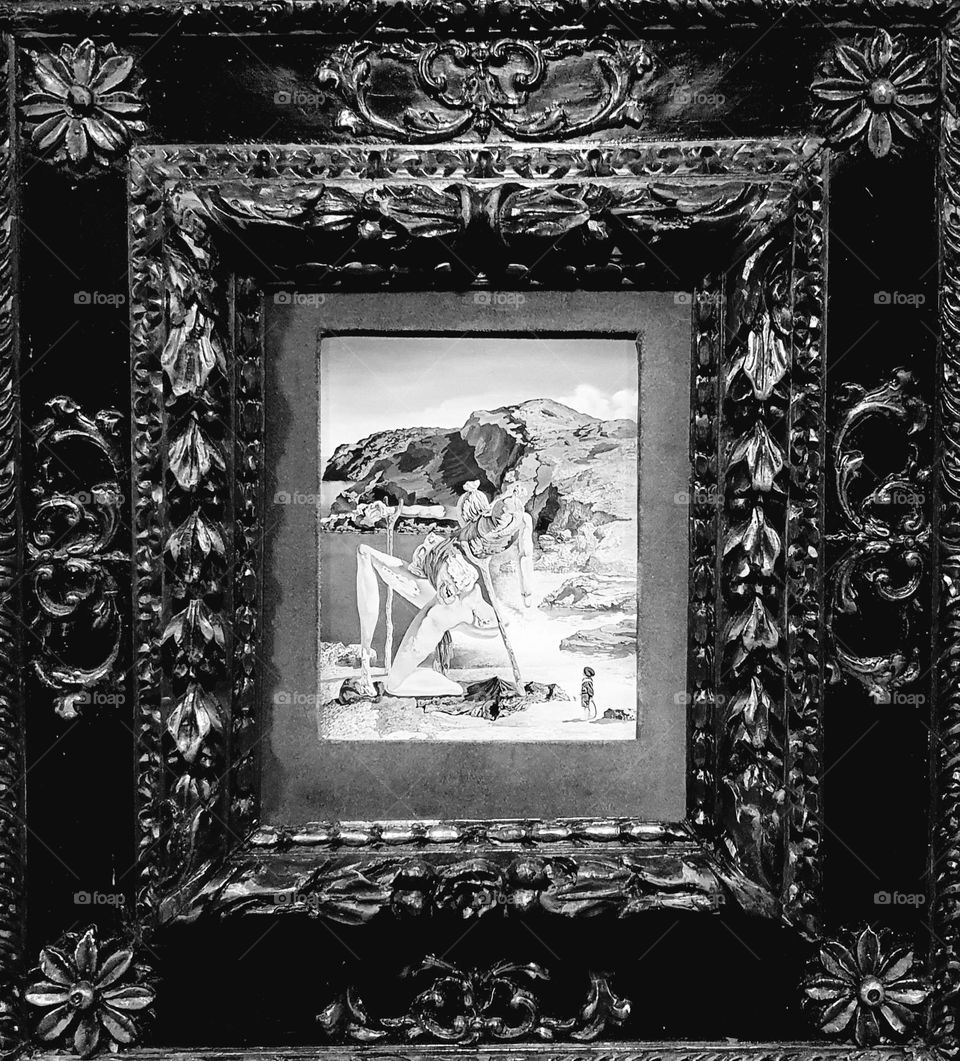 Black and white close-up shot of a vintage painting by Salvador Dali exposed in his theater museum of Figueras in Spain
