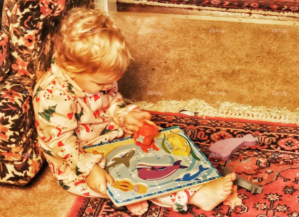 Little Girl With Puzzle. Child Playing With Shapes

