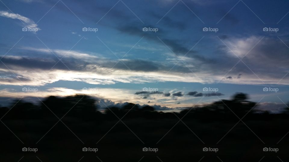 Moody, Cloudy Sky.  Black, gray, blue, white and golden clouds.