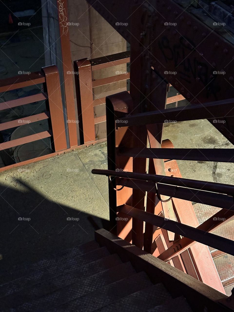 Interesting patterns develop at different times of the day or night when the red metal staircase of the “Pulaski Bridge” in LIC, Queens is illuminated by either the sun or artificial lighting after dark. 2023. Hypnotic Productions