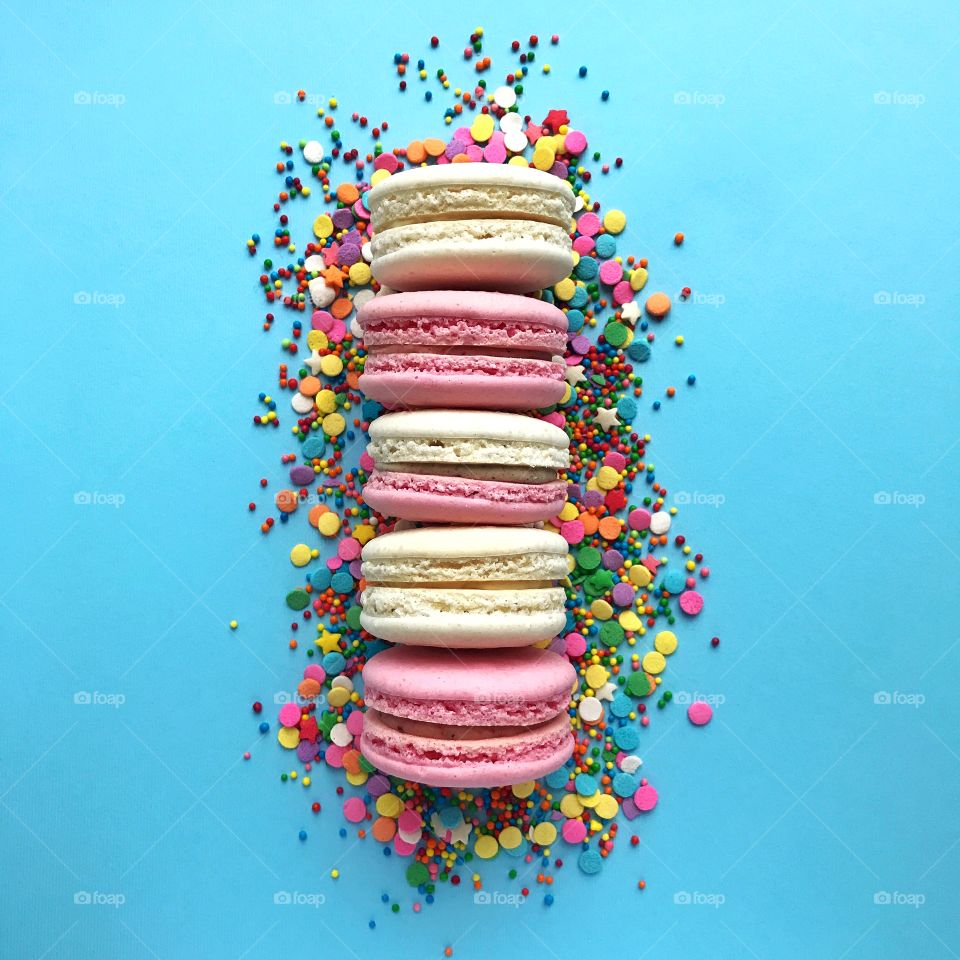 Colorful macaroons on blue background.