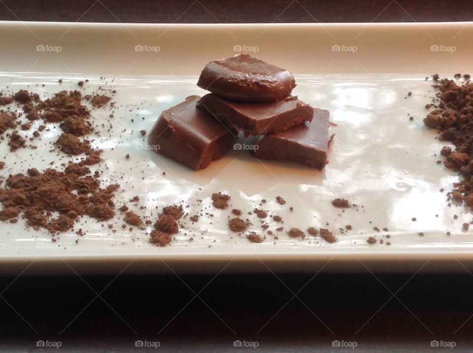 Pieces of fudge with cocoa powder.