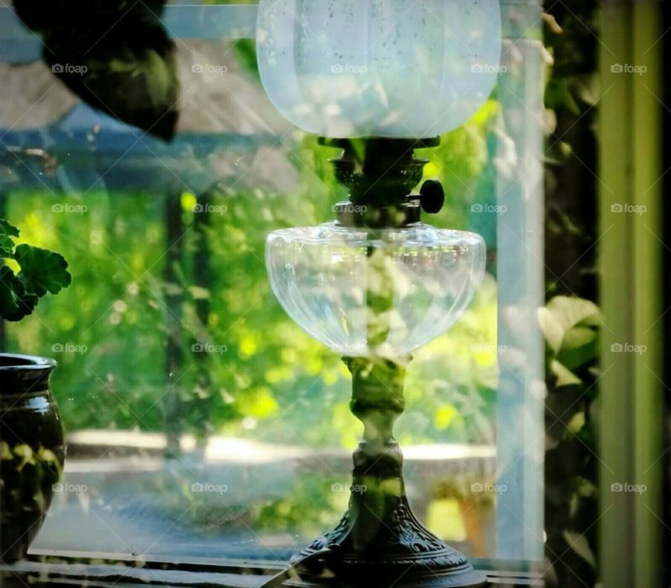 Old lamp in window