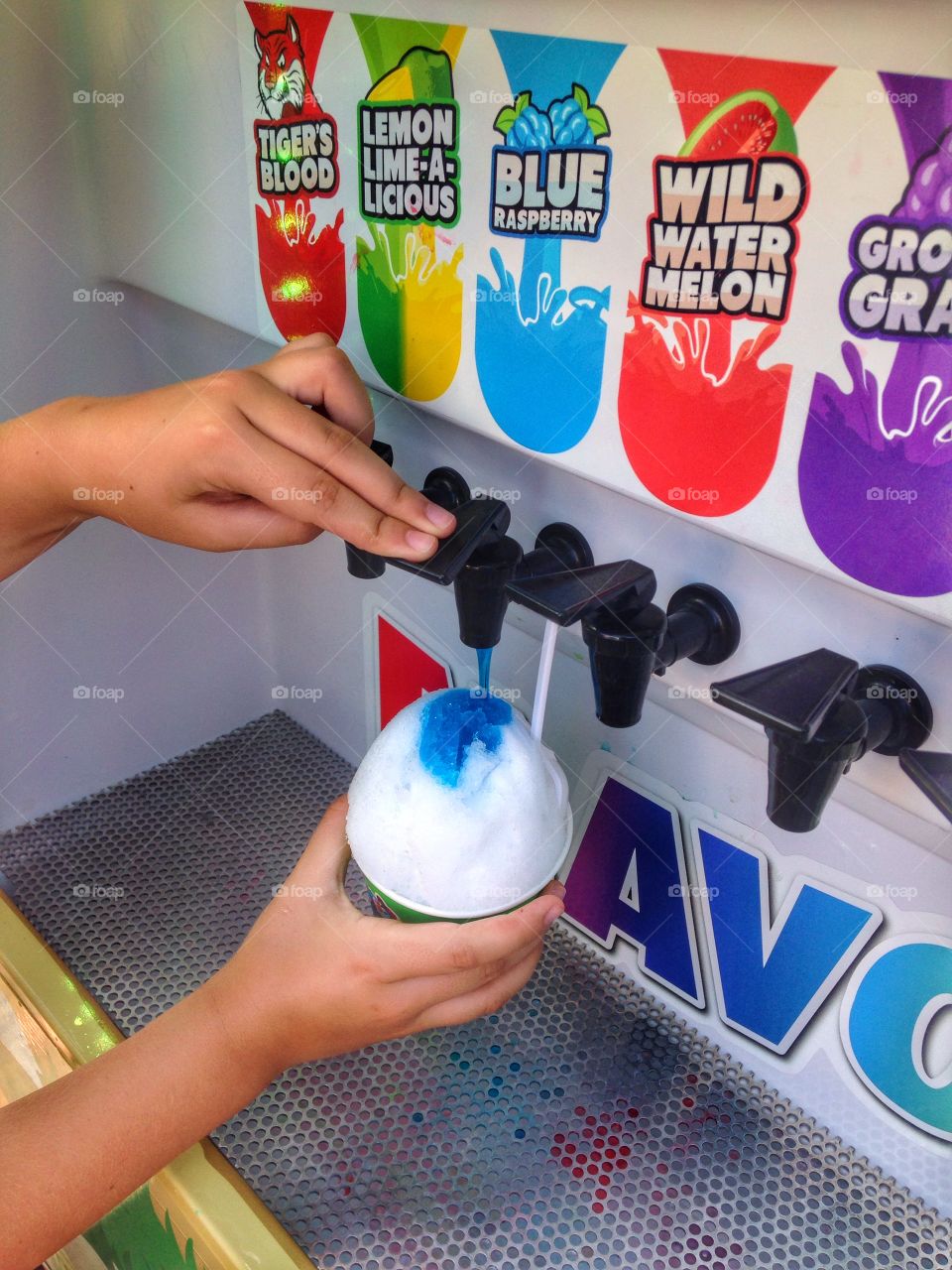 A delicious Summer. Girl getting a Kona ice snow cone