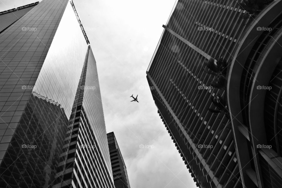 Black and white minimalist - Vertical architecture with a plane flying overhead  - 