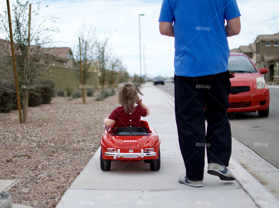 Little car driving car with dad