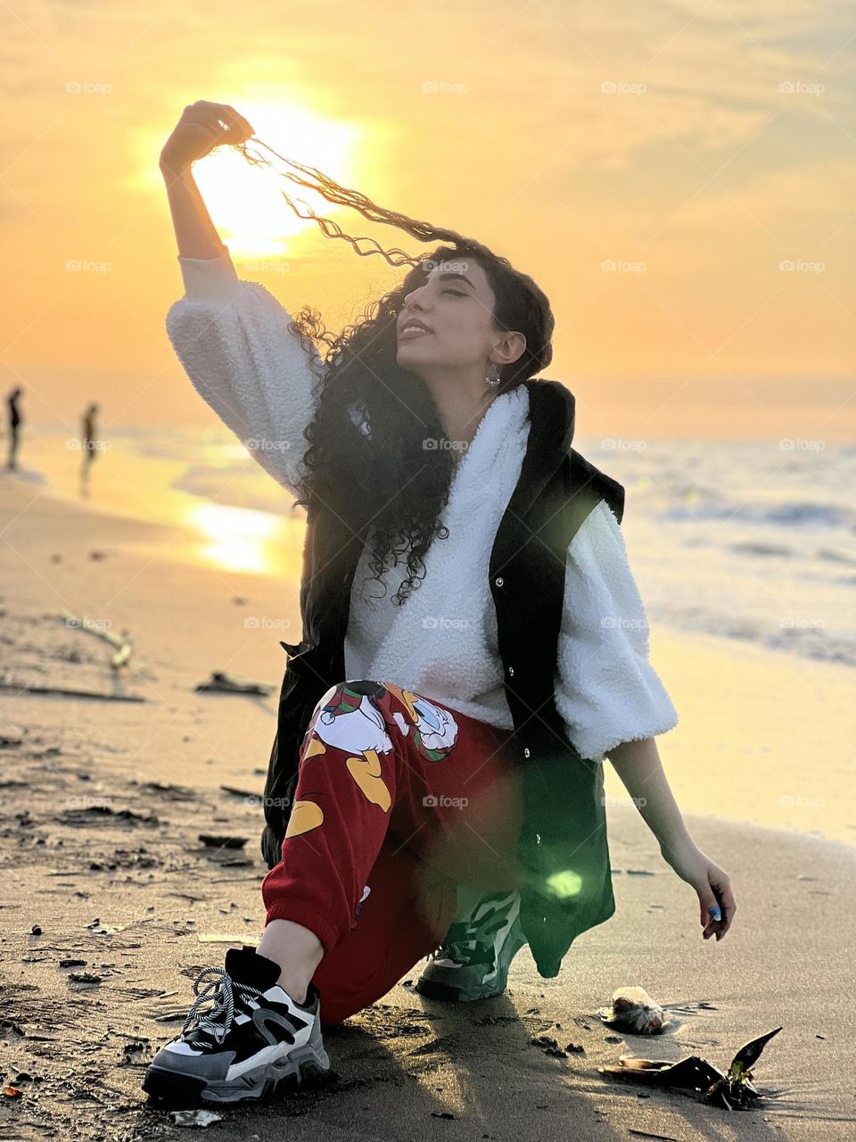 Curly haired girl enjoying the sunset