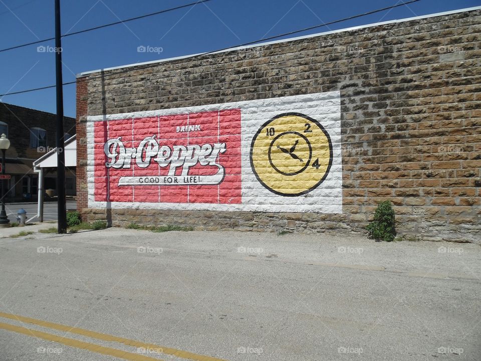 Dr Pepper. This is a picture of a sign displayed on the side of a building that I saw in Jacksboro Texas